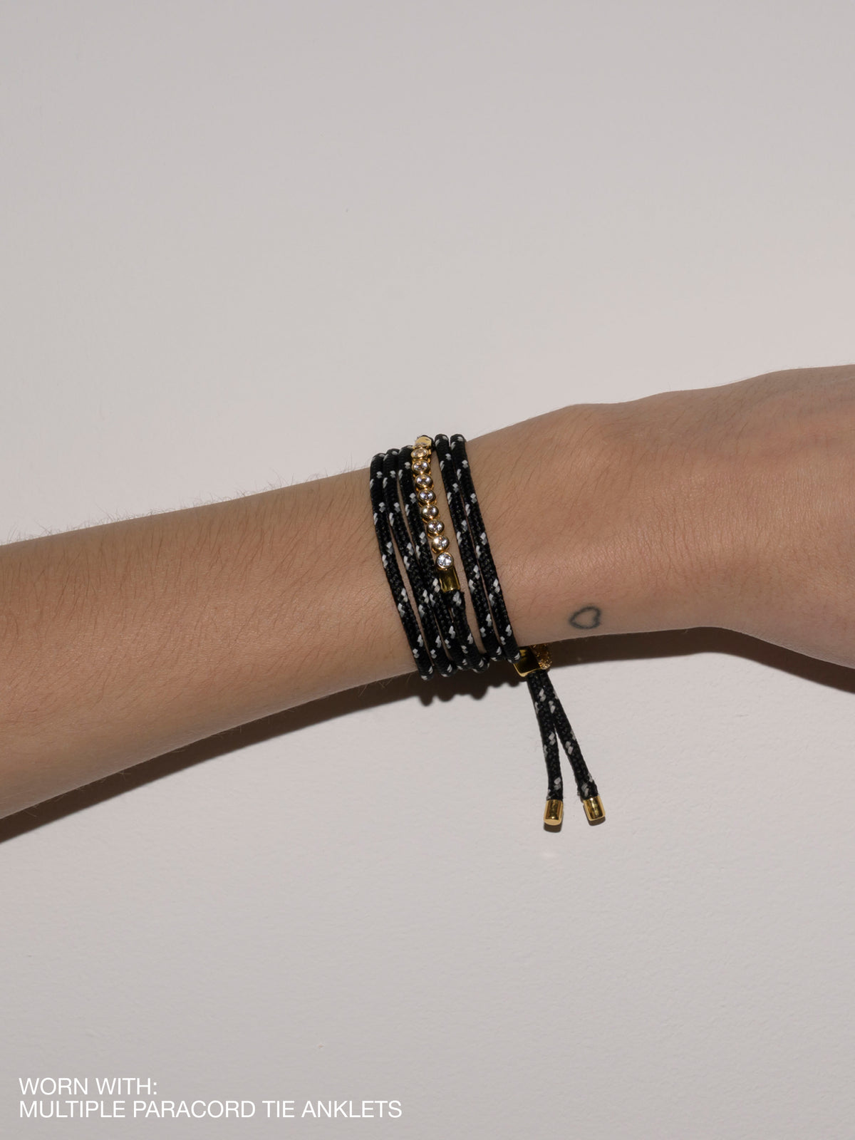 JAMES BEZEL NOIR ET BLANC PARACORD BRACELET, GOLD